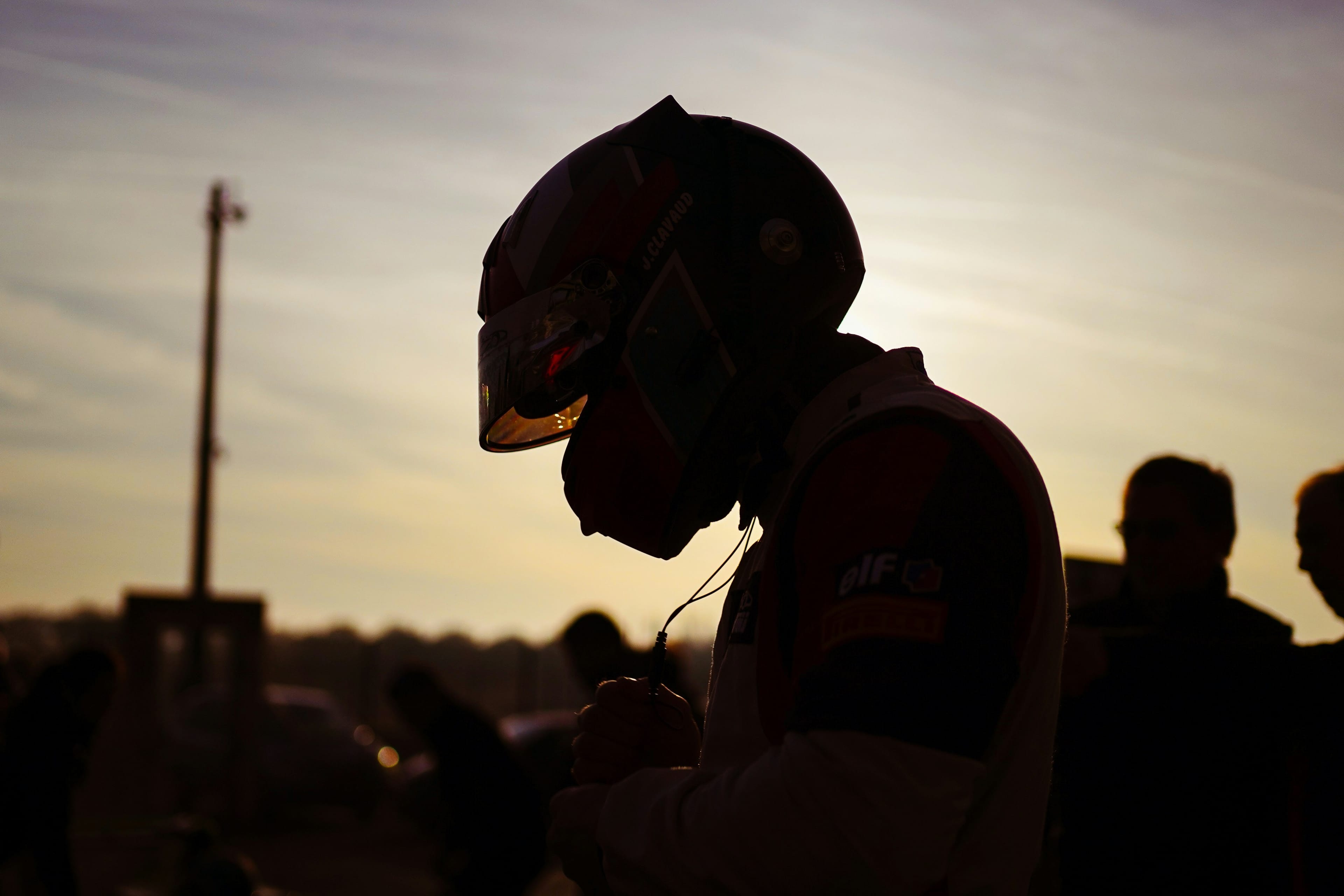 Silhouette of a driver wearing a helmet